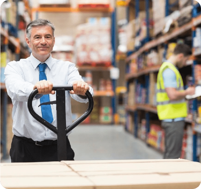 A man in a warehouse holding onto a handle.