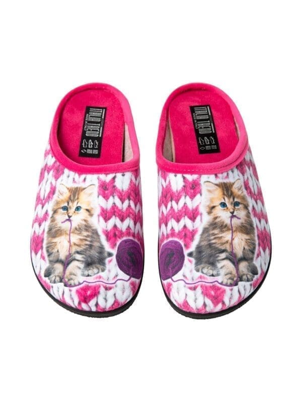 A pair of pink slippers with a cat on them.